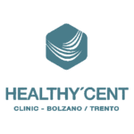 Logo della clinica HealthyCent, caratterizzato da un'icona esagonale con linee curve bianche e dal testo HEALTHY'CENT CLINIC - BOLZANO / TRENTO in lettere maiuscole e grassetto.